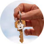 A man holding the key to an apartment.